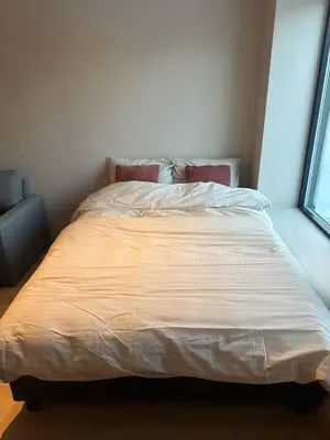 a large bed in a room with a window at Ålesund Campus Apartments in Ålesund