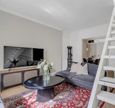 a living room with a couch and a table at Classic Bergen apartment peaceful space in the city center in Bergen