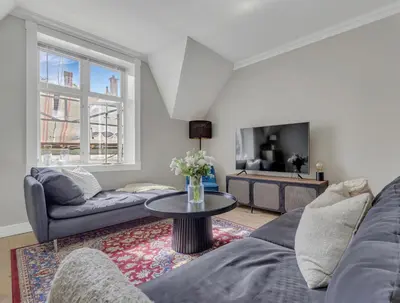 a living room with a couch and a table at Classic Bergen apartment peaceful space in the city center in Bergen