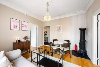 a living room with a white couch and a table at Bright City Apartment - Perfect Central Stay in Bergen