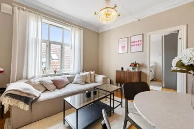 a living room with a couch and a table at Bright City Apartment - Perfect Central Stay in Bergen