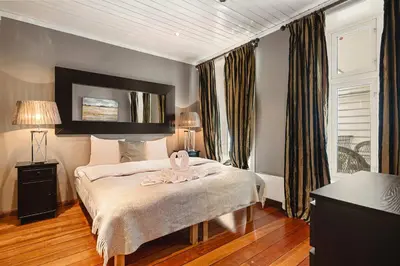 a bedroom with a bed with a towel on it at DINBNB Apartments l 50m to Bryggen l Multiple Apts l Balcony l View l Fireplace in Bergen