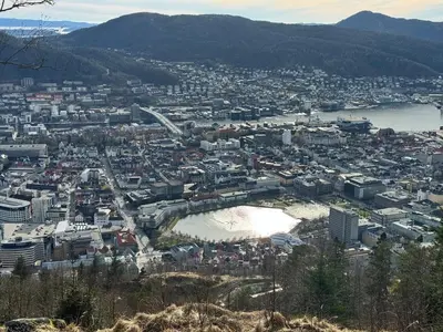 an aerial view of a city with a river and buildings at Bergenshus rett ved Bryggen i Bergen in Bergen