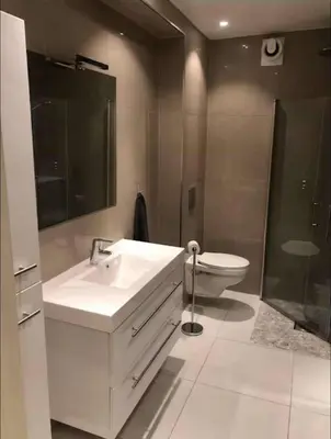 a bathroom with a white sink and a toilet at Moderne Leilighet midt i Bykjernen Apt 1 in Bergen