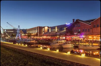 a group of boats docked in a marina at night at Modern three-room apartment, private terrace and roof terrace in Trondheim