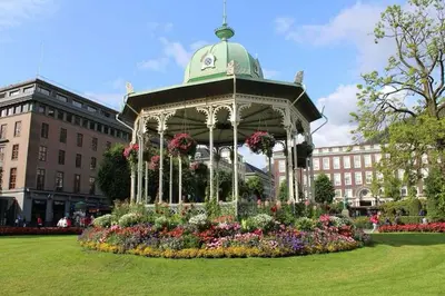a gazebo in the middle of a park with flowers at Moderne Leilighet midt i Bykjernen in Bergen