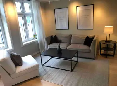 a living room with a couch and a coffee table at Moderne Leilighet midt i Bykjernen in Bergen