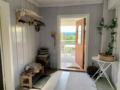 a hallway with a door leading to a patio at Landlige Peru in Ringsaker