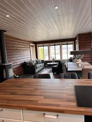 a living room with a couch and a table at Drøm deg bort til fjells Velkommen til en perle av en hytte in Masfjorden