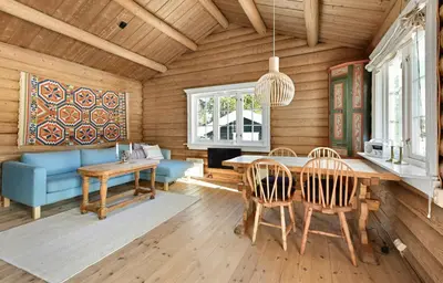 a dining room with a table and chairs at Atmospheric Log Cabin By Myllavannet
