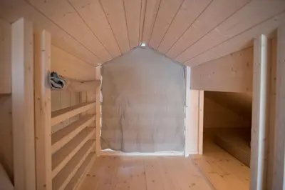 a small room in a wooden cabin with a bed in it at Sørbølhytta by Norgesbooking - cabin in Flå, close to Bjørneparken in Flå