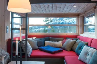 a red couch in a room with a window at Sørbølhytta by Norgesbooking - cabin in Flå, close to Bjørneparken in Flå