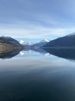 a view of a lake with snow covered mountains at Faleide Grandview in Stryn