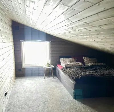 a bedroom with a bed and a window at Large Familycabin In Fageråsen in Trysil