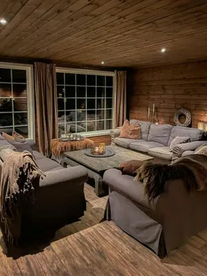 a large living room with couches and a table at Large Familycabin In Fageråsen in Trysil