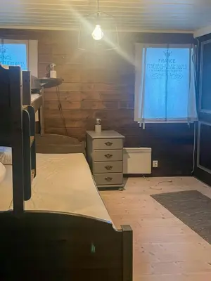 a room with a bed and a dresser and a window at Large Familycabin In Fageråsen in Trysil