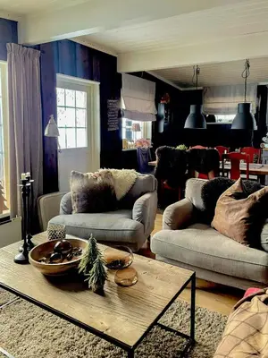 a living room with two couches and a table at Large Familycabin In Fageråsen in Trysil