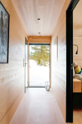 a room with a door leading to a bedroom with a window at Modern Light Neo Cabin On Bjefell in Svene