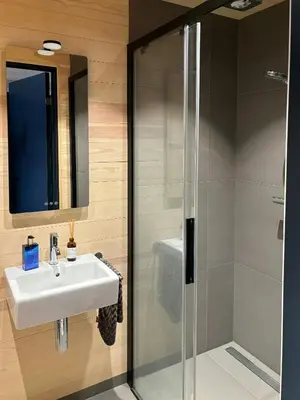 a bathroom with a sink and a shower at Modern Light Neo Cabin On Bjefell in Svene