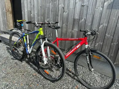 two bikes are parked next to a fence at Modern Light Neo Cabin On Bjefell in Svene