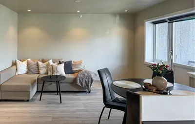 a living room with a couch and a table at 2 Bedroom Cozy Apartment In Laksevåg in Bergen