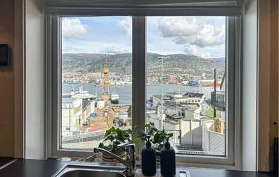 a kitchen window with a view of a harbor at 2 Bedroom Cozy Apartment In Laksevåg in Bergen