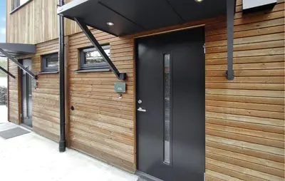 a black door on the side of a house at Amazing Apartment In Bjorli in Bjorli