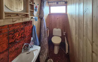 a small bathroom with a toilet and a sink at Nice Home In Hatlestrand With Wifi in Hatlestrand