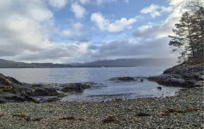 a large body of water with a rocky beach at Nice Home In Hatlestrand With Wifi in Hatlestrand