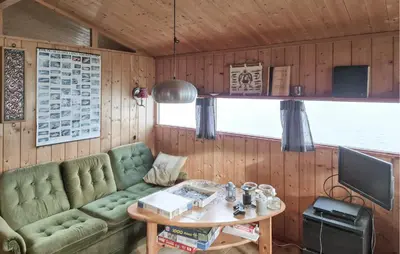 a living room with a green couch and a table at Nice Home In Hatlestrand With Wifi in Hatlestrand