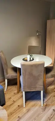 a table and chairs with a white table and a table and chairs at Casa Gamle Bergen in Bergen