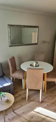 a room with a table and chairs and a mirror at Casa Gamle Bergen in Bergen
