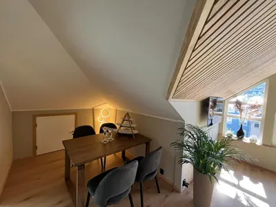a dining room with a wooden table and chairs at Modern Apartment Vaskerelven 12 in Bergen