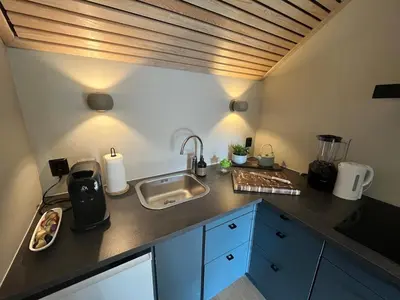 a kitchen with a sink and a counter top at Modern Apartment Vaskerelven 12 in Bergen