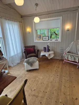 a living room with a couch and a chair at Feriebolig Fannrem in Torshus