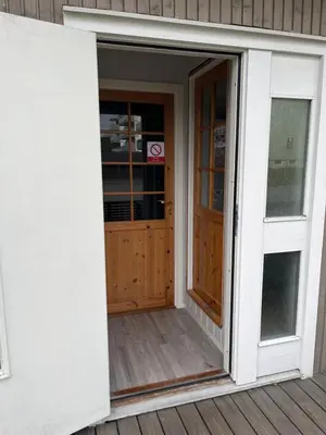 an open door of a house with a porch at Loft apartment with 3 bedrooms in Trondheim