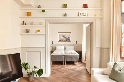 a living room with a bed and a television at F7 l Architects Choice in Bergen