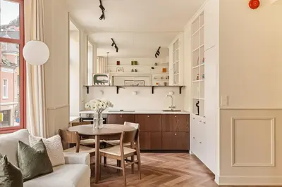 a kitchen and living room with a table and chairs at F7 l Architects Choice in Bergen