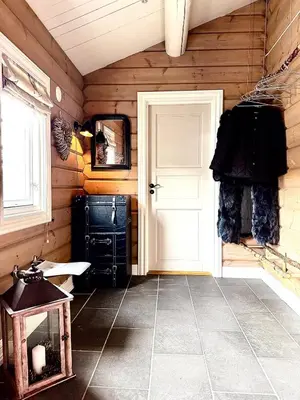 a room with a white door in a wooden wall at Gateway to Hardangervidda - Fireplace, Ski trails, Nature reset in Maurset