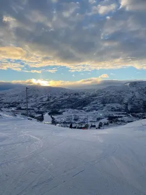 a snow covered hill with a view of a city at Gateway to Hardangervidda - Fireplace, Ski trails, Nature reset in Maurset