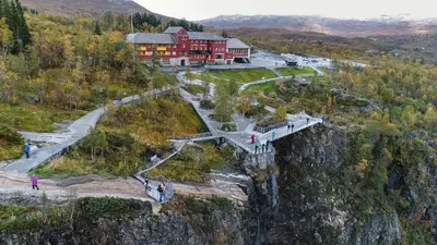 a building on the side of a mountain with a bridge at Gateway to Hardangervidda - Fireplace, Ski trails, Nature reset in Maurset