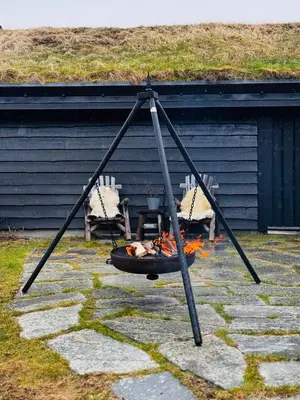 a swing with two chairs and a fire at Gateway to Hardangervidda - Fireplace, Ski trails, Nature reset in Maurset