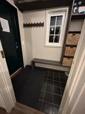 a hallway with a window and a bench in a room at Røldal ski in ski out in Håra