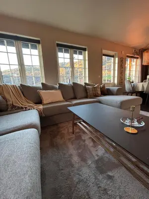 a living room with a couch and a table at Røldal ski in ski out in Håra