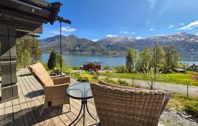 a patio with a view of a lake and mountains at 4 Bedroom Stunning Home In Tørvikbygd in Tyrvikbygd