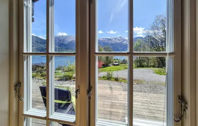 a window looking out at a view of a yard at 4 Bedroom Stunning Home In Tørvikbygd in Tyrvikbygd