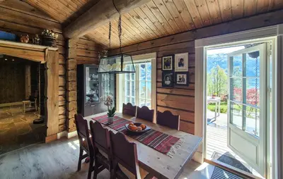a dining room with a table and a large window at 4 Bedroom Stunning Home In Tørvikbygd in Tyrvikbygd