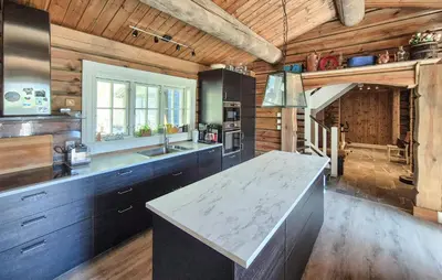 a large kitchen with wooden walls and a counter top at 4 Bedroom Stunning Home In Tørvikbygd in Tyrvikbygd