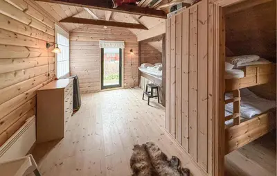 a cabin with a dog laying in the middle of a room at Pet Friendly Home In Hovden I Setesdal in Hovden