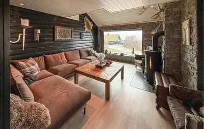 a living room with a couch and a table at Pet Friendly Home In Hovden I Setesdal in Hovden
